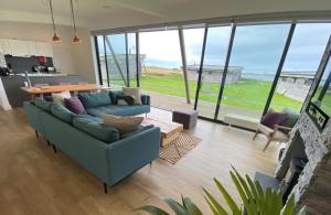 a living room with a couch and a table at Jog Lodge 10 By Together Travel - 3 Bed in John O Groats