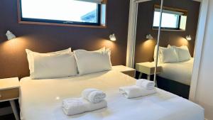 a hotel room with two towels on a bed at Jog Lodge 10 By Together Travel - 3 Bed in John O Groats