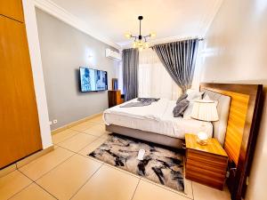 a bedroom with a bed and a rug at LOUMIA Residency in Douala