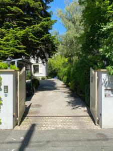 an empty driveway with a gate and trees at Residence Mont-Blanc in Geneva
