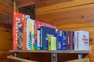 a bunch of books sitting on a shelf at Raven Rock Getaway- Firepit Nights Getaway in Rapid City