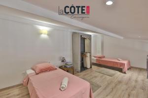 a hospital room with two beds and pink sheets at A La Vaquera - Gîte équestre in Châteauneuf-lès-Martigues