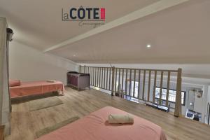 a attic room with two beds and a staircase at A La Vaquera - Gîte équestre in Châteauneuf-lès-Martigues +10 photos