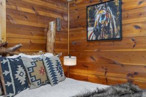 a bedroom with a bed and a painting of a horse on the wall at Raven Rock Getaway- Firepit Nights Getaway in Rapid City