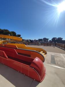 a slide at a skate park with the sun in the background at Lou Soleil - Bungalow - 6 couchages in Carry-le-Rouet