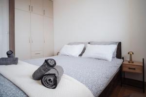 a bedroom with a bed with towels on it at Sky View - Apartment & GARAGE, Banja Luka in Banja Luka