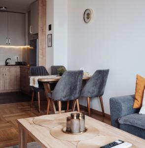 a kitchen and living room with a table and chairs at Sky View - Apartment & GARAGE, Banja Luka in Banja Luka