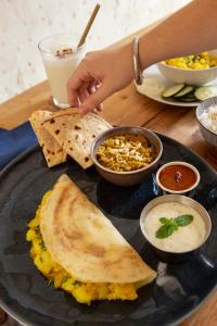 a plate with a plate of food on a table at The Vedam Hotels - Ram Mandir Ayodhya A unit of RL Group of Hotels Ayodhya in Ayodhya