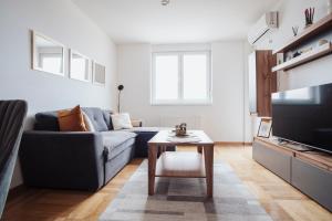 a living room with a couch and a coffee table at Sky View - Apartment & GARAGE, Banja Luka in Banja Luka