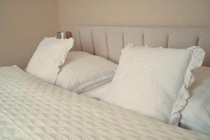 a bed with two pillows on top of it at Bohemian in Šamorín