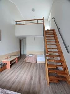 a room with a bunk bed and a staircase at Dom Litewski in Sejny +26 photos