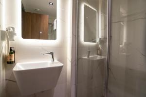 a white bathroom with a sink and a shower at Kucuk Velic Hotel in Gaziantep +34 photos