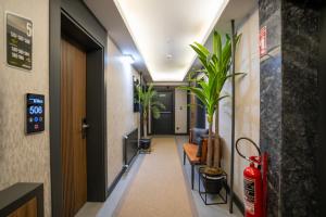 a corridor with plants in a hallway at Kucuk Velic Hotel in Gaziantep