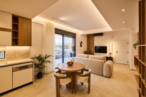 a living room with a table and a couch at POLYTELIA - Luxury Living in Elaía