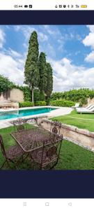 a table and chairs in front of a swimming pool at Masseria Buganvillea in Fasano