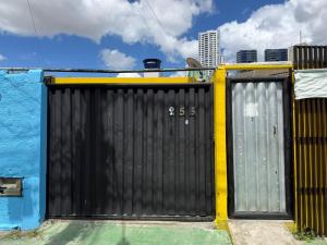 a black gate with the number thirtyfive on it at Jampa Pousada Sb in João Pessoa