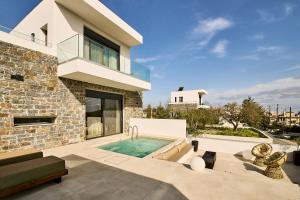 a house with a swimming pool in the backyard at POLYTELIA - Luxury Living in Elaía