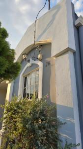 a blue house with a window on the side of it at La Casa de Miranda in San Miguel