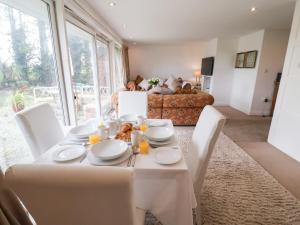 a dining room with a white table and chairs at Three Ways in Diss