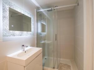 a white bathroom with a shower and a sink at Three Ways in Diss +12 photos