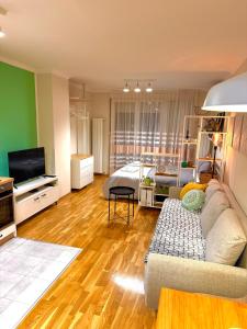 a living room with a couch and a bed at Studio 4 in Pirot