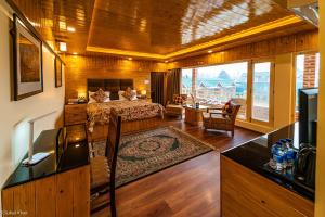 a bedroom with a bed and a living room at The Orchard Retreat & Spa in Srinagar