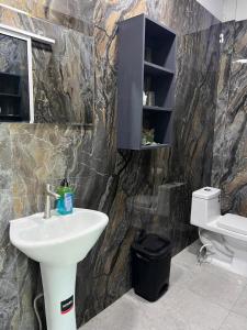 a bathroom with a sink and a toilet at Mi Tierra Surf City in El Majahual