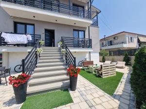 a house with stairs and flowers in a yard at JD villa in Vlorë