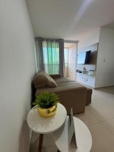 a living room with a bed and a table and a couch at 2 quartos a 300m do mar do bessa in João Pessoa