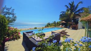 a swimming pool with a view of the ocean at Villa ALDIANA in Cap Skirring