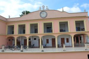 a building with a clock on the top of it at Residence Hotel Torresilvana in Vieste