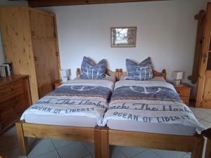 a bedroom with a large bed with blue pillows at Bungalow Poggendorf in Eldena