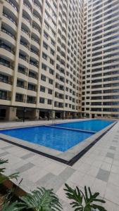 a swimming pool in front of a large building at Golden Seagulls Hotel in Manila