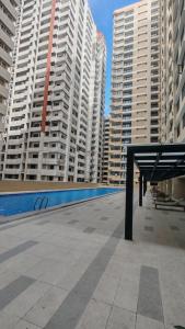 a view of a swimming pool in a city with tall buildings at Golden Seagulls Hotel in Manila