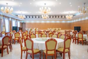a conference room with tables and chairs and chandeliers at Fude Hotel T bilis第比利斯富德酒店 in Tbilisi City
