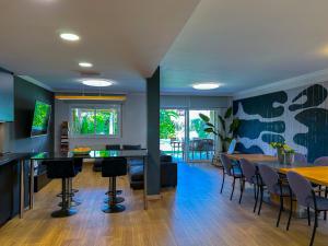a living room with a table and chairs at Villa Rocamar by Hello Homes Sitges in Sitges