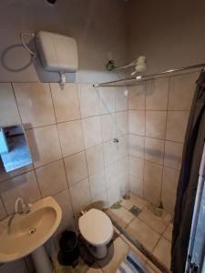 a bathroom with a toilet and a sink at Kitnet Apart-Hotel 4 in Sete Lagoas +15 photos