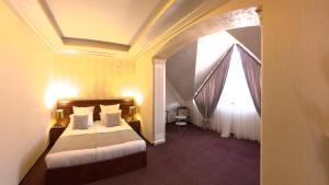a hotel room with a bed and a window at Passage Hotel Restaurant in Goris
