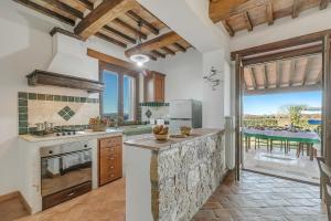 a kitchen with a counter and a large window at Le Sorgenti in Pitigliano