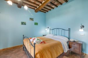 a bedroom with a bed in a blue room at Le Sorgenti in Pitigliano
