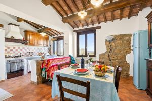 a kitchen with a table with a bowl of fruit on it at Le Sorgenti in Pitigliano