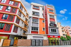an orange and white building with a sign on it at Hotel O MAJESTIC M2 INN in New Town +22 photos