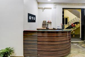 a lobby with a wooden bar in a building at Hotel O MAJESTIC M2 INN in New Town