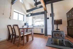 a kitchen and dining room with a table and a stove at 皓雲庵 in Miyakonojō