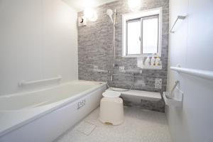 a bathroom with a tub and a toilet and a sink at 皓雲庵 in Miyakonojō +14 photos