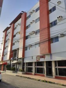 an apartment building with red and white at Residencial Sol - Cidade alta in Natal
