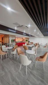 a waiting room with tables and chairs in a building at Golden Seagulls Hotel in Manila