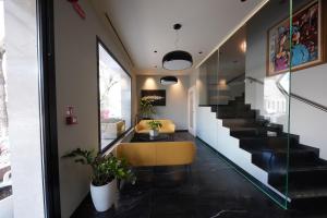 a living room with a yellow chair and stairs at Maritan Hotel & Spa in Padova