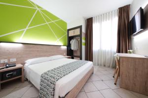 a hotel room with a large bed and a desk at Maritan Hotel & Spa in Padova