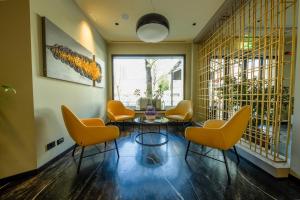 a lobby with chairs and a table and a window at Maritan Hotel & Spa in Padova